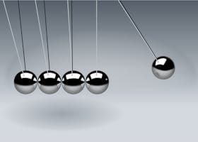 Dynamic illustration of Newton's Cradle showing motion and reflection concepts in physics.