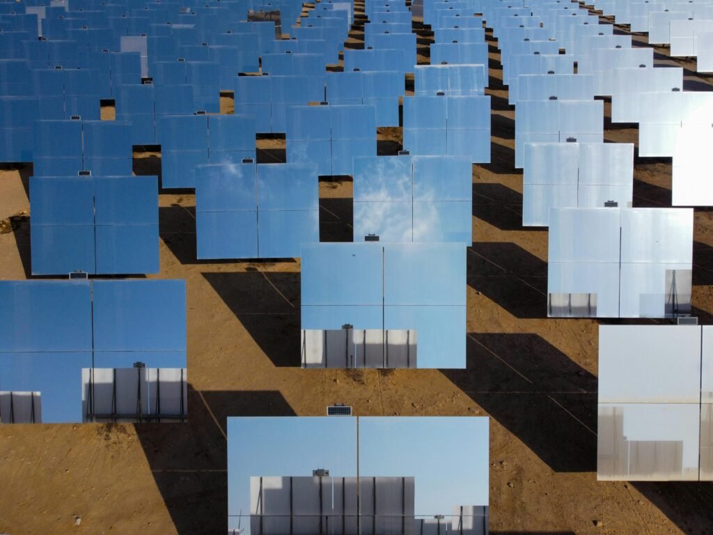Aerial shot of multiple reflective solar panels highlighting the scalability of mobile apps usage