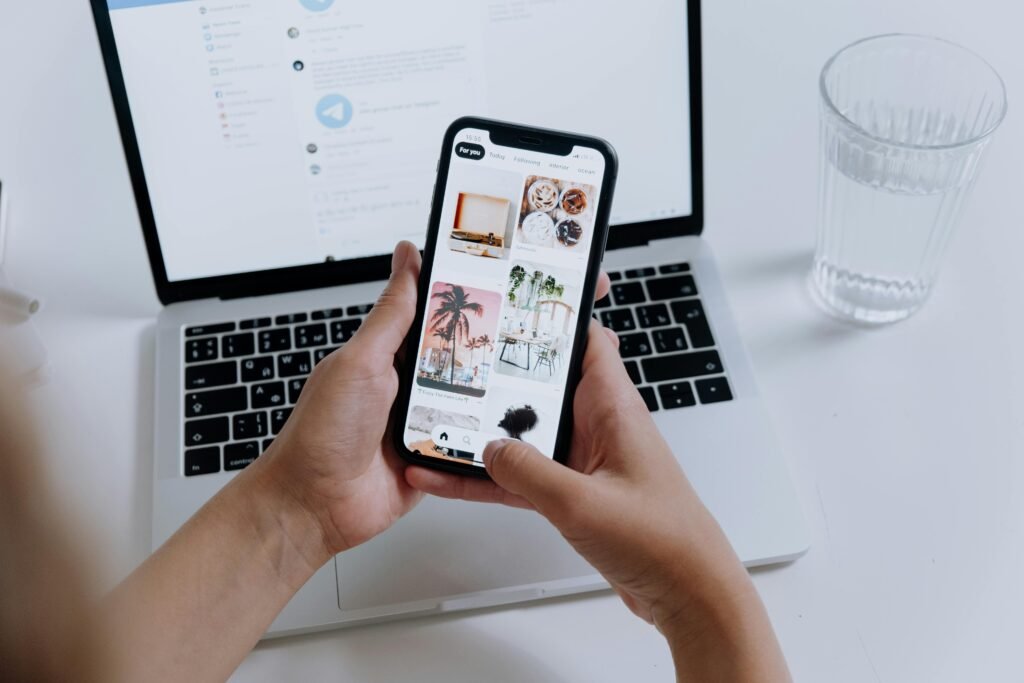 A professional holding a smartphone showcasing a gallery, indicating the mobile apps usage becoming a necessity